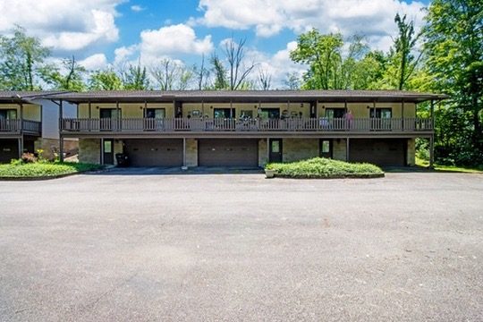 Creekside Apartments building in Smithville with garages below and balconies above