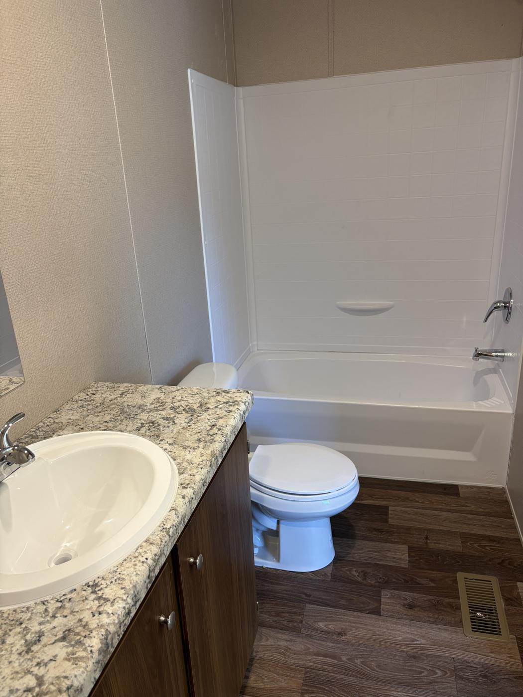 Bathroom with tub and shower, toilet and vanity