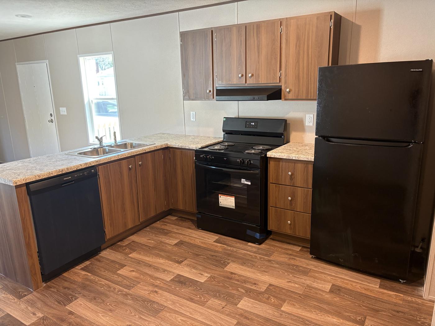 Kitchen with wood cabinets, gas range, dishwasher and refrigerator